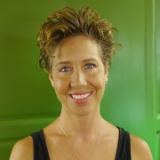 Slightly smiling woman with short brown hair